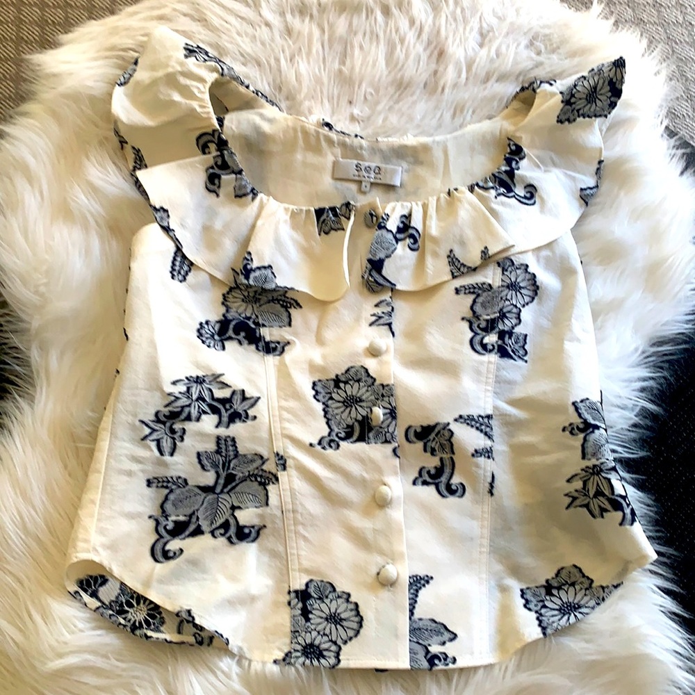 Beautiful Sea top with navy blue flower appliqués, wide shoulder with ruffles.